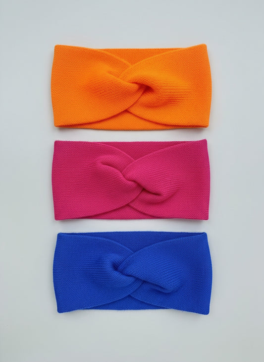 Three colorful headbands (orange, pink, blue) handmade by 100% baby alpaca in Bolivia by TINKU