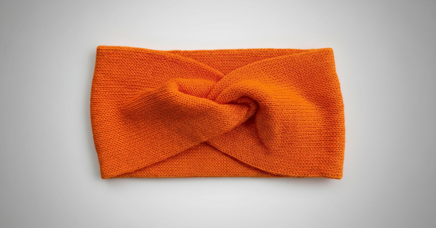 Orange knotted 100% baby alpaca headband handmade in Bolivia by TINKU